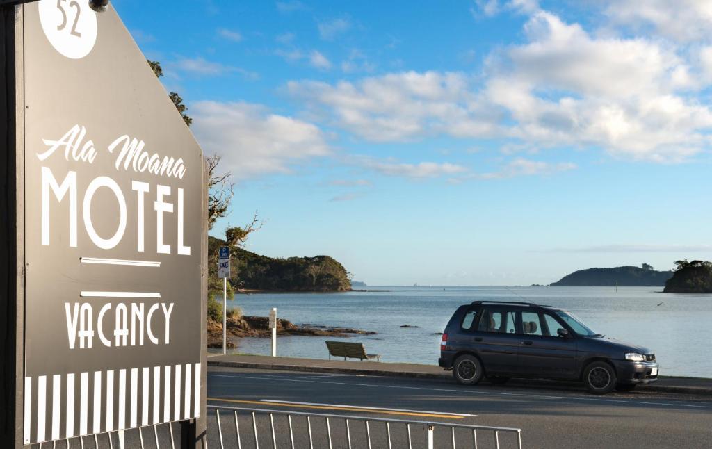 a car parked on the side of a road near the water at Ala Moana Motel in Paihia