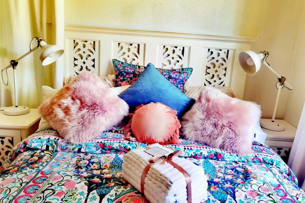 a bed with colorful pillows with mongols on it at Central Located 4BR Home with Rumpus & King Bed in the Heart of Melbourne in Chadstone