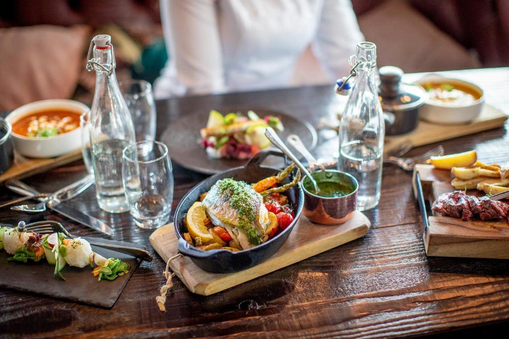 uma mesa de madeira com um prato de comida em Leonardo Hotel Papendrecht em Papendrecht