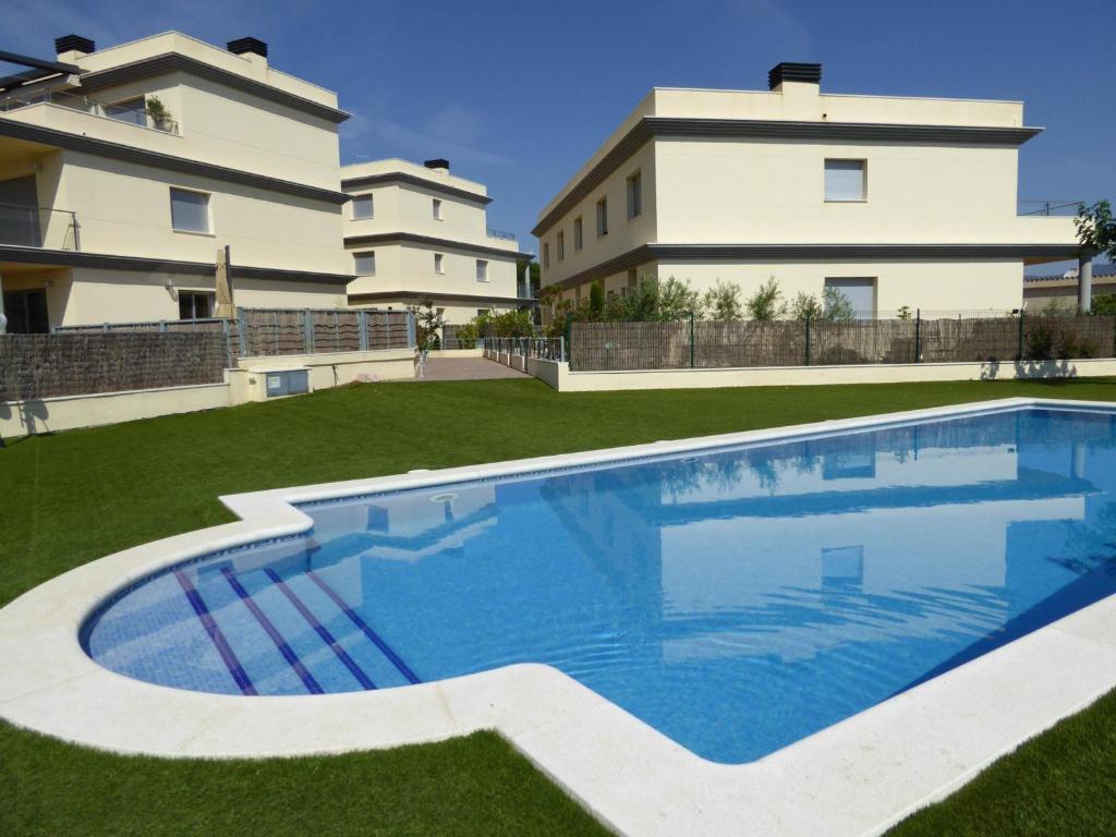 uma piscina num quintal ao lado de um edifício em Apartamento Llançà, 2 dormitorios, 4 personas - ES-228-137 em Llançà