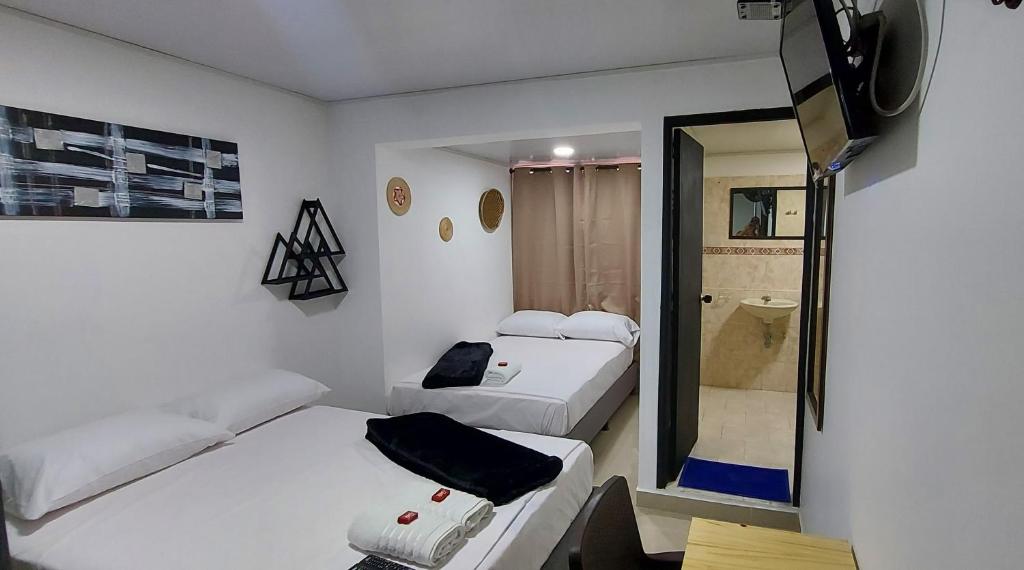 Postel nebo postele na pokoji v ubytování Aparta Hotel la 80 Estadio