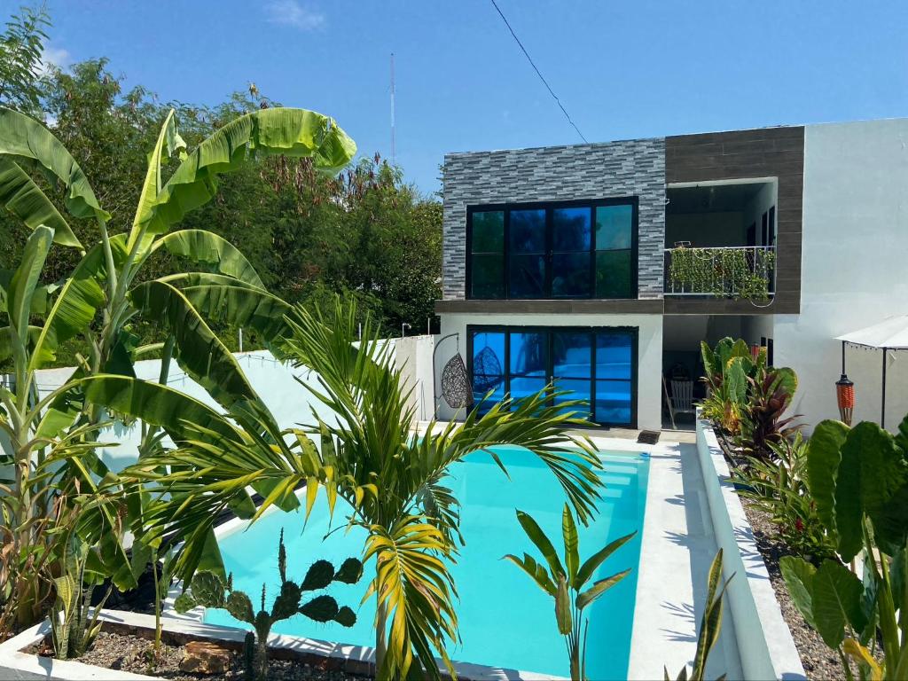 a house with a swimming pool in front of a house at Apartamento independiente en casa in Girardot