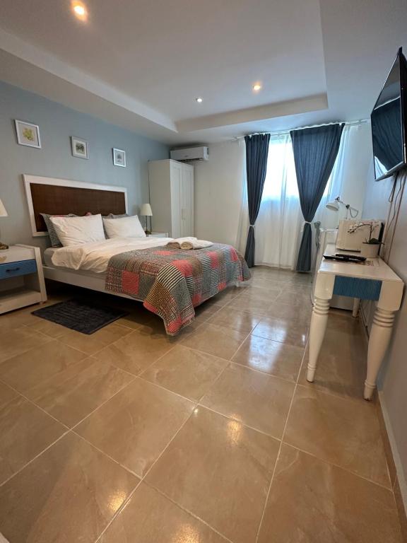 a bedroom with a bed and a desk and a sink at Noe Hotel One BedRoom #3 in Punta Cana