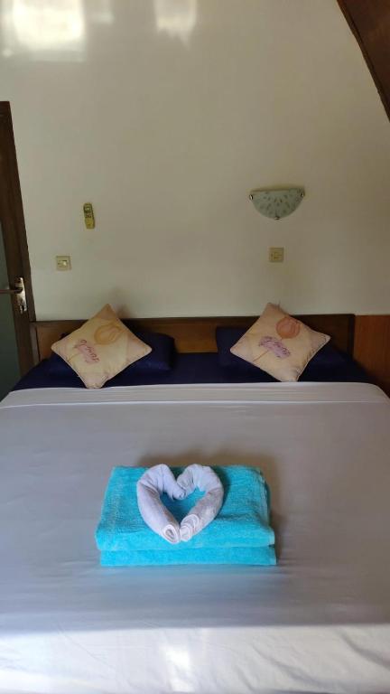 Postel nebo postele na pokoji v ubytování Meno Turtle BUNGALOWS