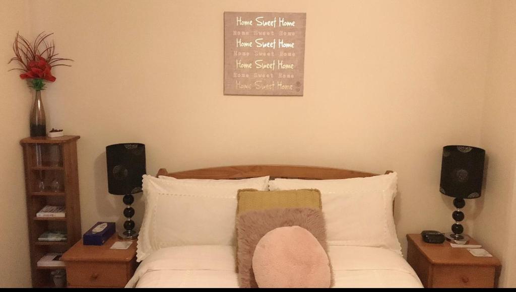 a bedroom with a bed with two speakers and a picture on the wall at Comfy Home in Aberdeen