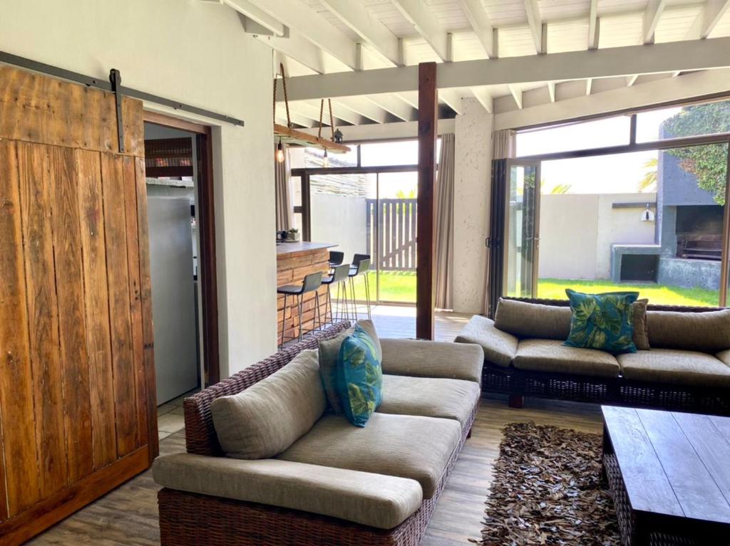 a living room with two couches and a table at Langstrand Beach House in Langstrand