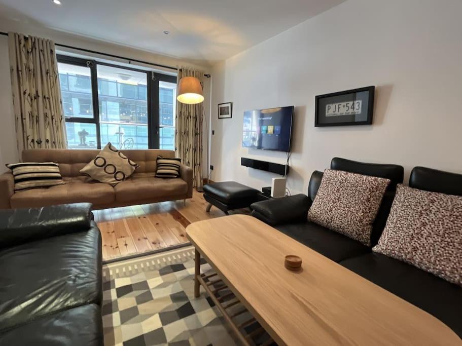 a living room with a couch and a table at Sir John Rodgerson Apartment in Dublin
