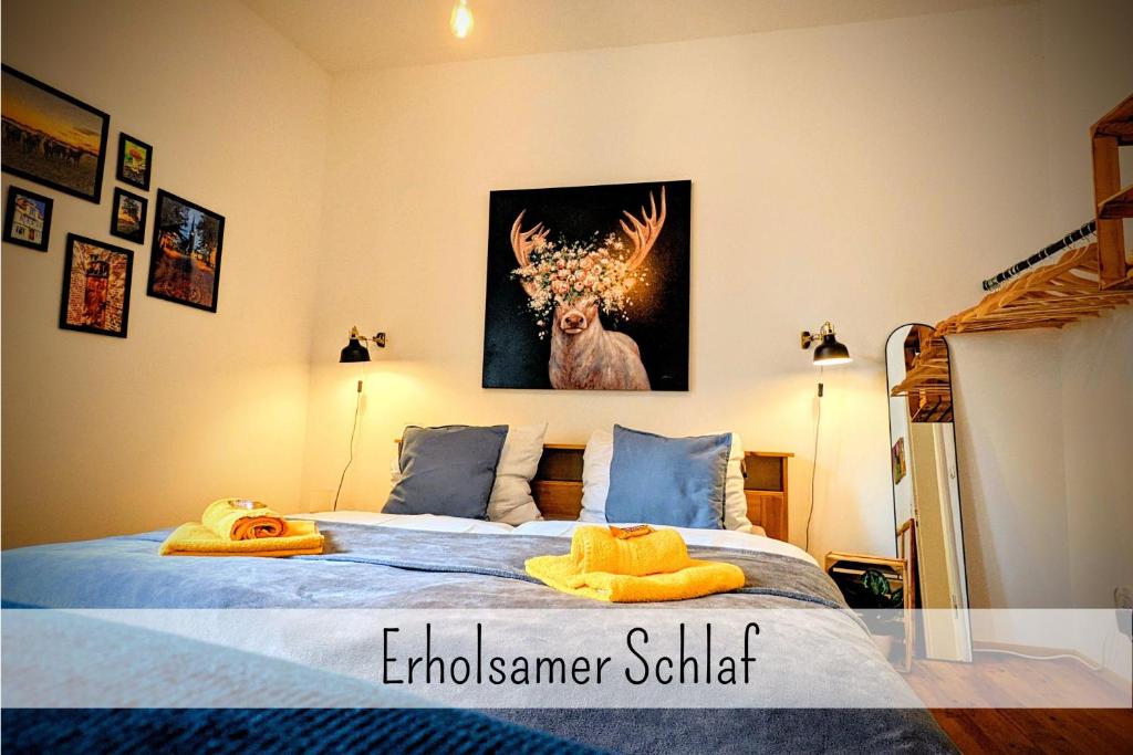 a bedroom with a bed with a picture of a deer at Uhlpartment - Romantisches Apartment im Zentrum in Uelzen