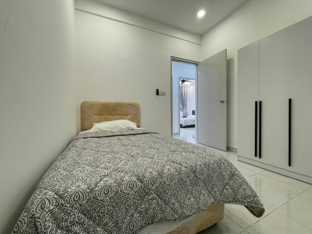 a bedroom with a bed in a white room at Bayu Andaman KL Centre in Kuala Lumpur