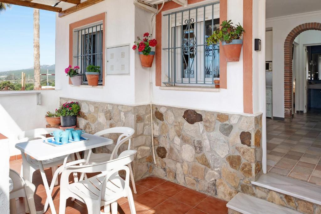 a patio of a restaurant with a table and chairs at Casa Vistas al Mar Bolonia in Tarifa