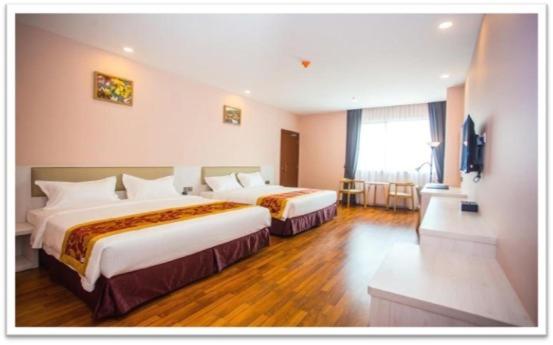 Postel nebo postele na pokoji v ubytování Austin Park Hotel