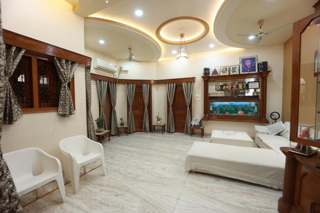 a large living room with a bed and a couch at Kapoor Sahab Homestay : it's a home away from home. in Varanasi