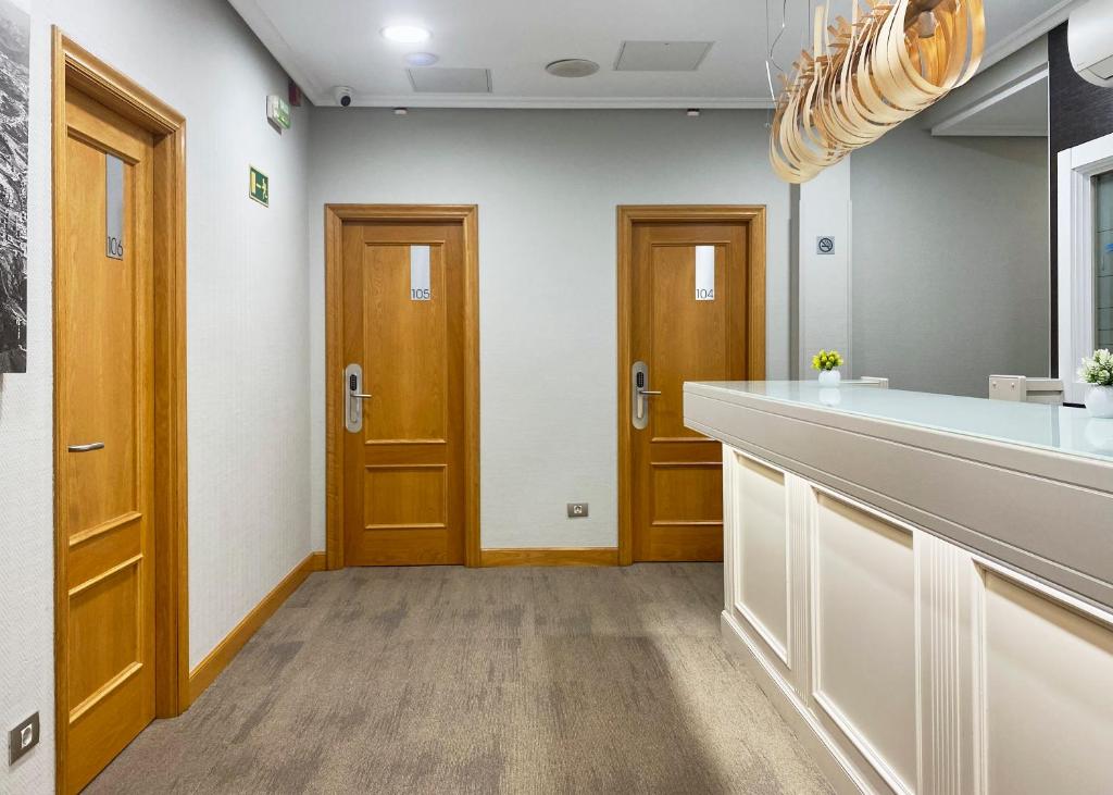 a kitchen with a counter and two wooden doors at Pensión Alemana in San Sebastián