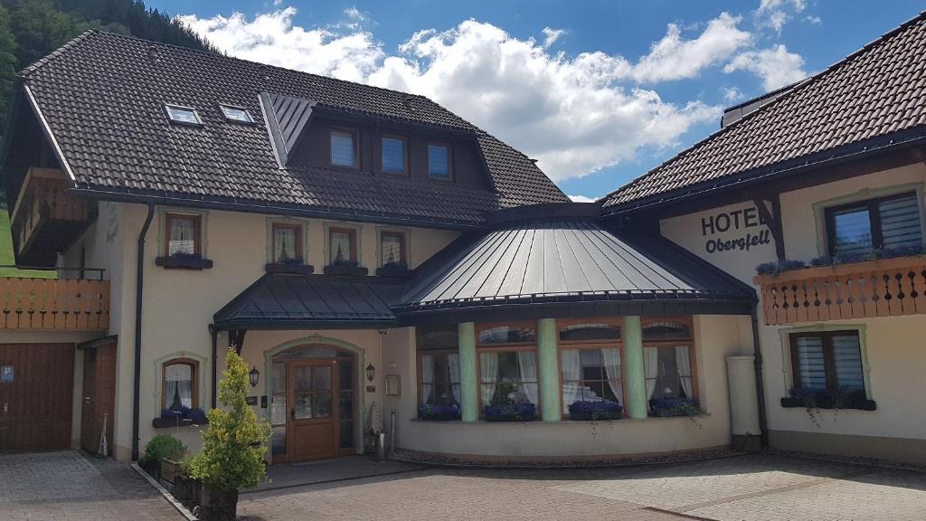 a hotel building with a metal roof at Hotel Obergfell in Todtnau