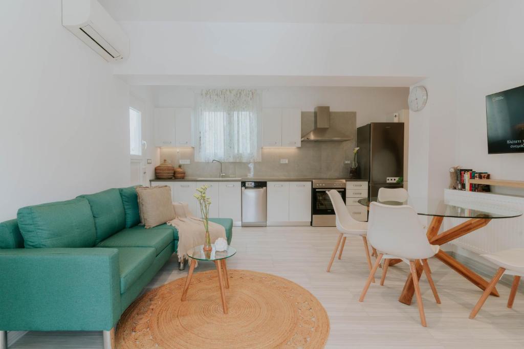 a living room with a green couch and a table at Kaliva Residence in Kalamaki