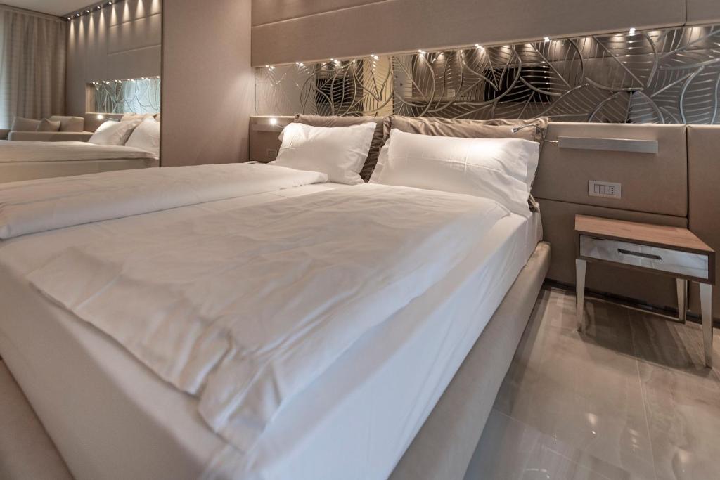 a bedroom with two large beds with white sheets at Park Hotel Imperial in Limone sul Garda