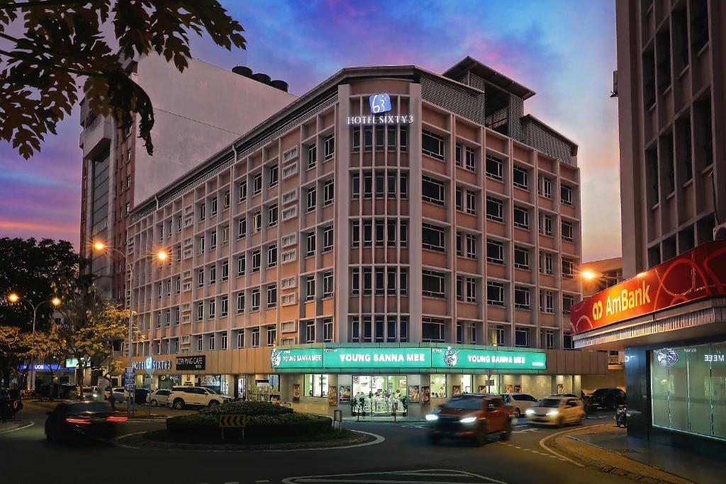 a large building with cars driving in front of it at Hotel Sixty3 in Kota Kinabalu