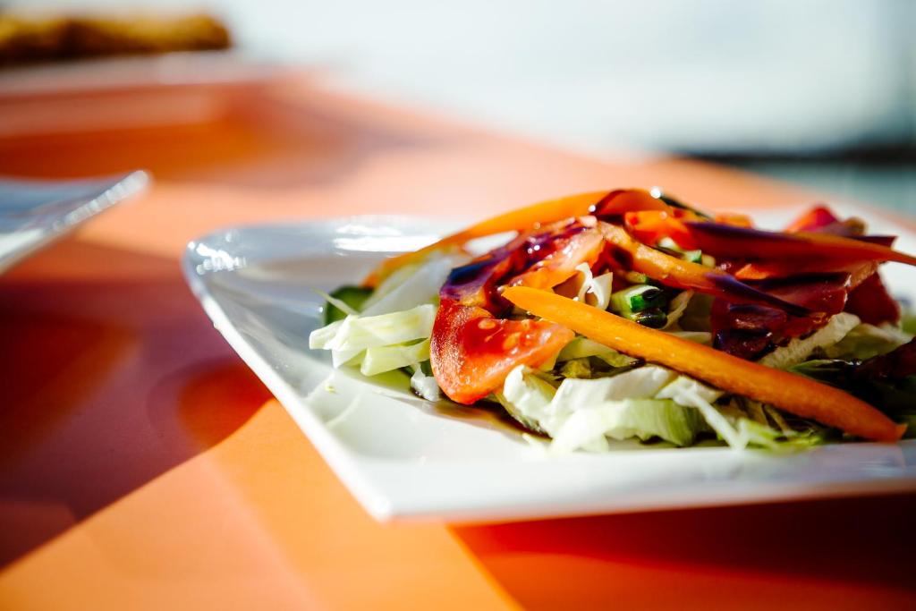 a plate of salad with vegetables on a table at Sissi Park in Lachtal