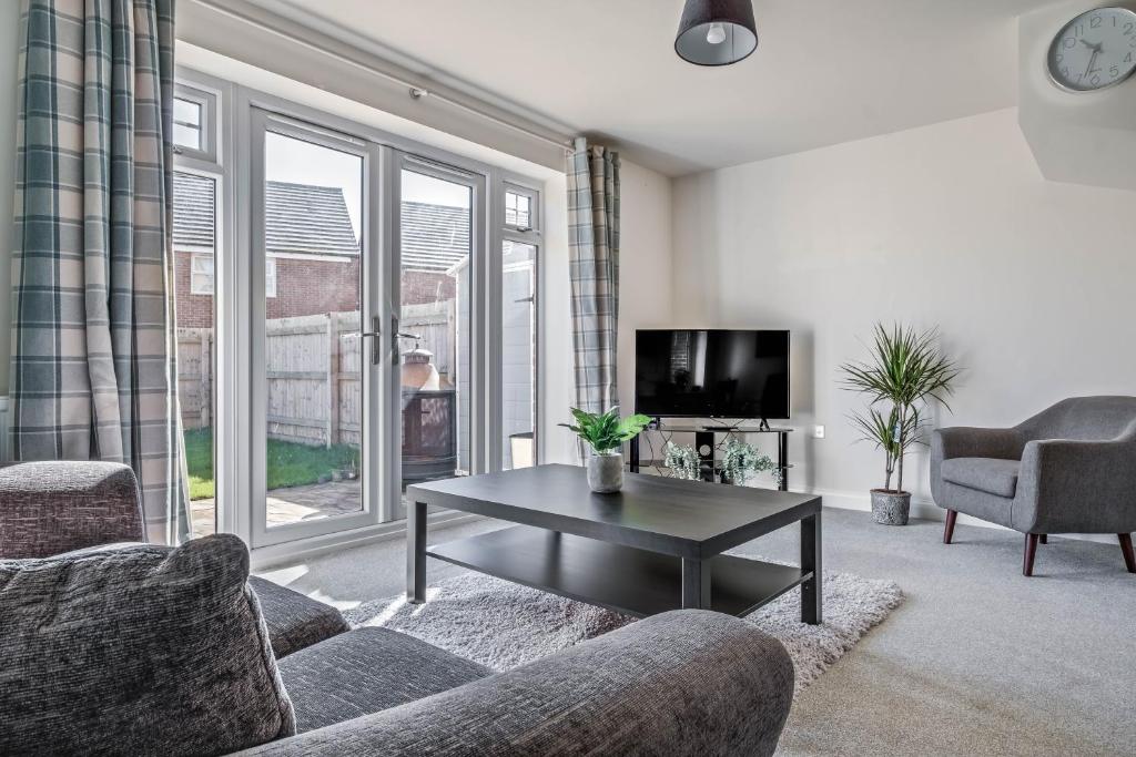 a living room with a couch and a coffee table at Beautiful and Comfortable Home away from Home in Northampton