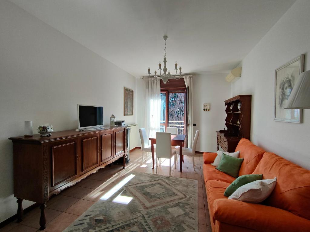 a living room with a couch and a dining room at Fabula Home Rental - GiannaRosa in Lovere