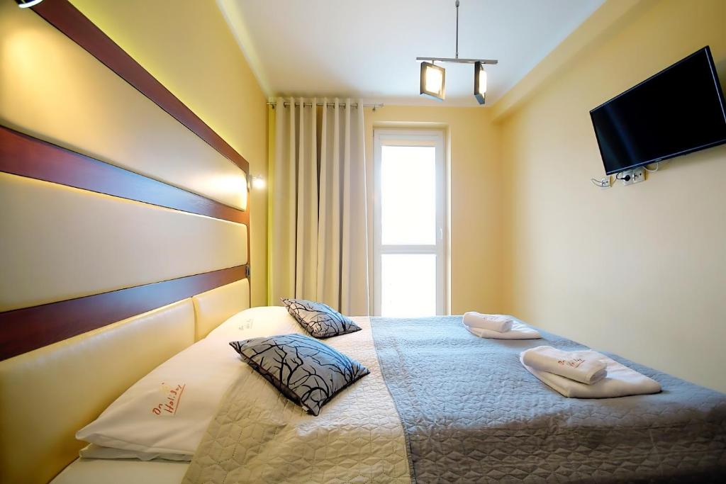 Posteľ alebo postele v izbe v ubytovaní OnHoliday Apartamenty w Hotelu przy ul Kościuszki 16