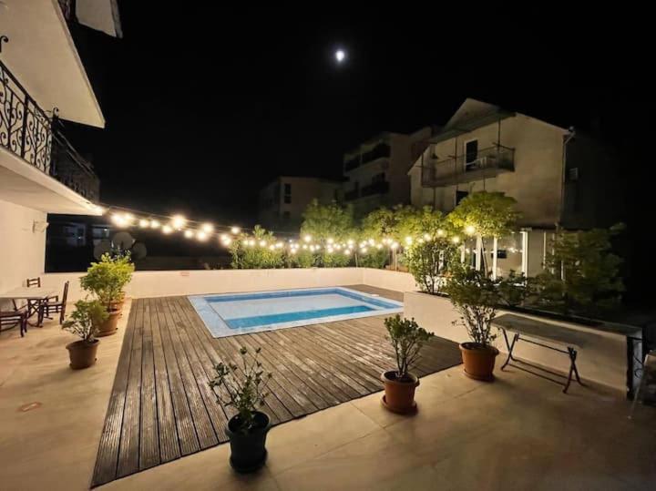 a patio with a swimming pool at night with lights at Del Mar in Ureki