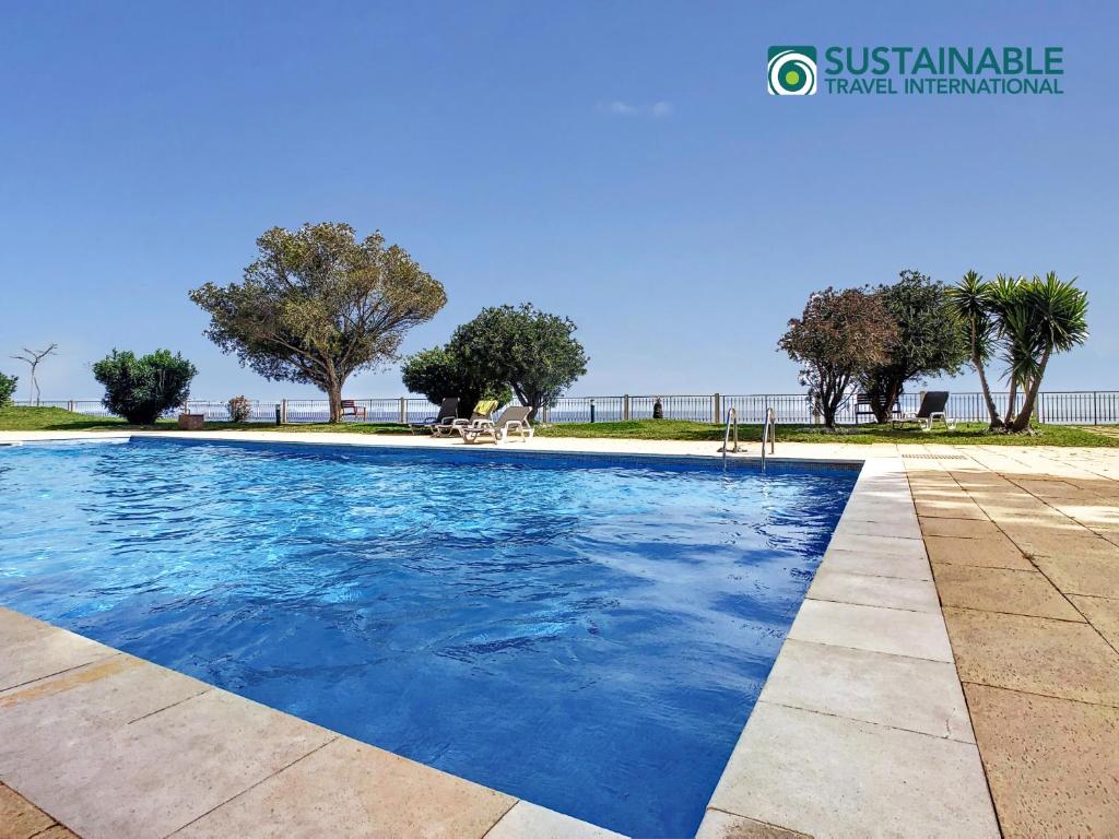 una piscina in una villa con vista sull'oceano di Private Sunset Terrace & Ocean Cliff Pool Garden at Designer Apt by LovelyStay a Funchal