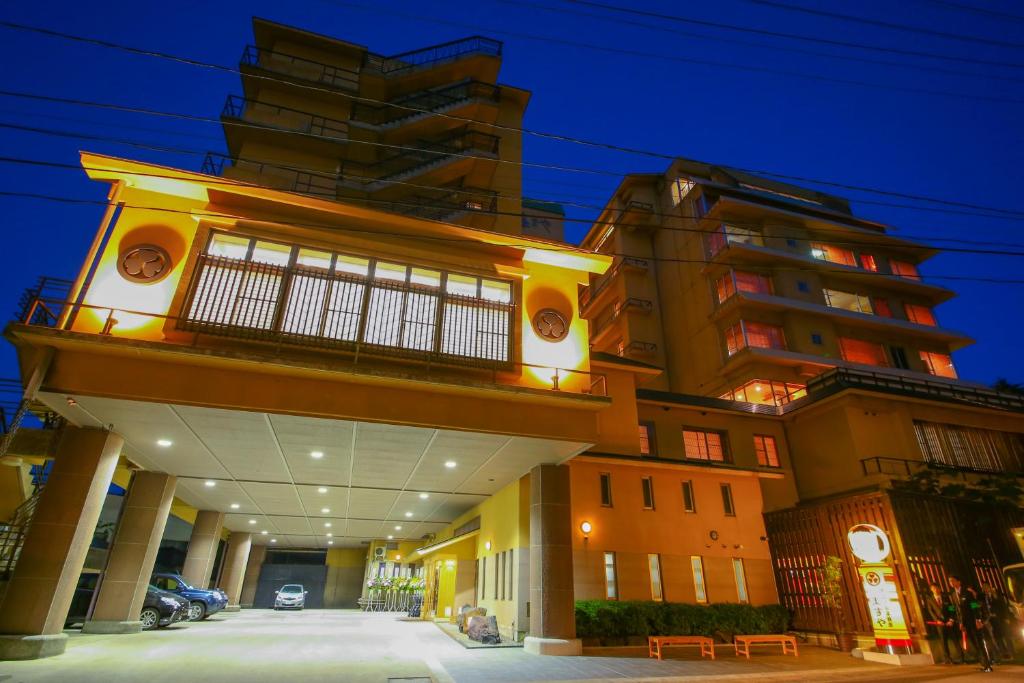 a large building at night with a building at Ooedo Onsen Monogatari Masuya in Osaki