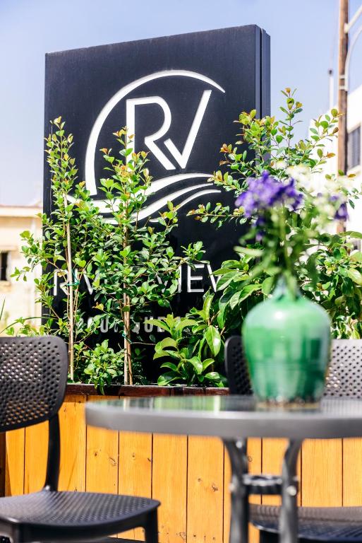 a table with a vase on top of it with plants at River View Boutique Apts in Ayia Napa