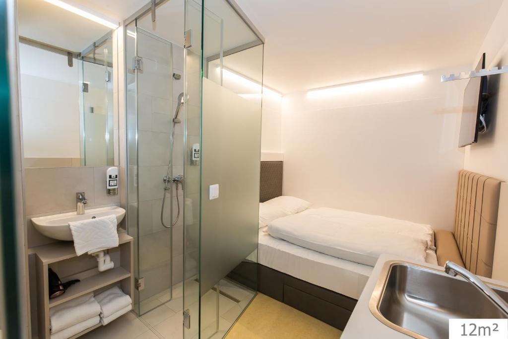 a bathroom with a shower and a sink at Smart Nano Living - Wien Hauptbahnhof in Vienna