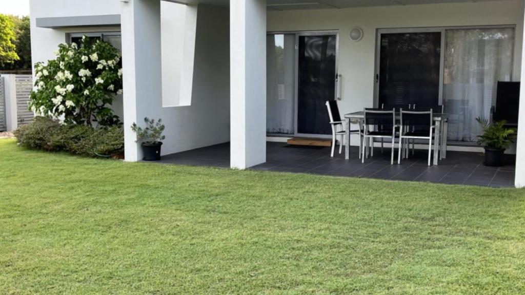 a patio with a table and chairs in a yard at 1 - 5a Coochin Street, Dicky Beach - 200m To Beach in Caloundra