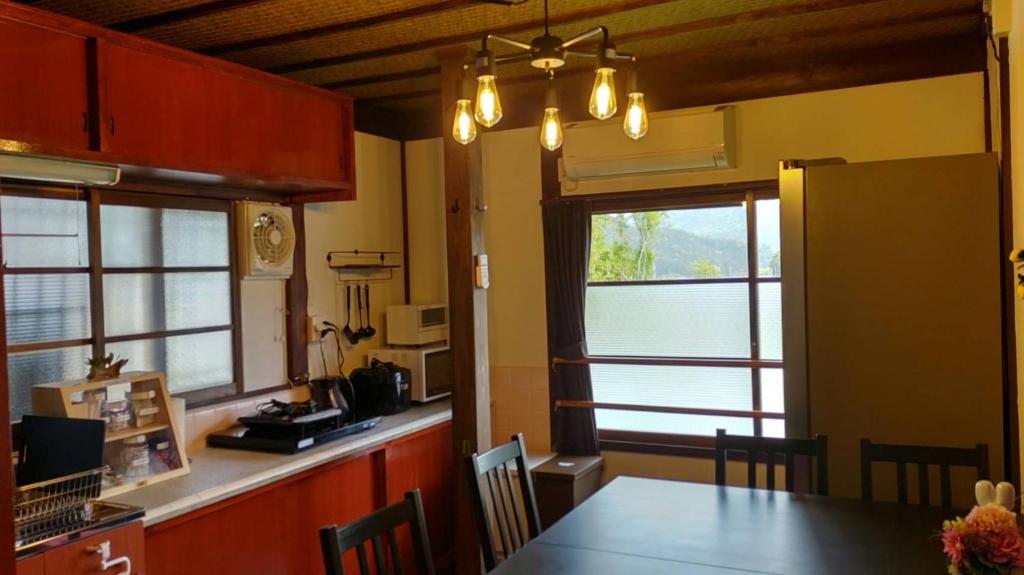 a kitchen with a dining table and a window at ドッグラン併設 しまなみ御殿 in Imabari
