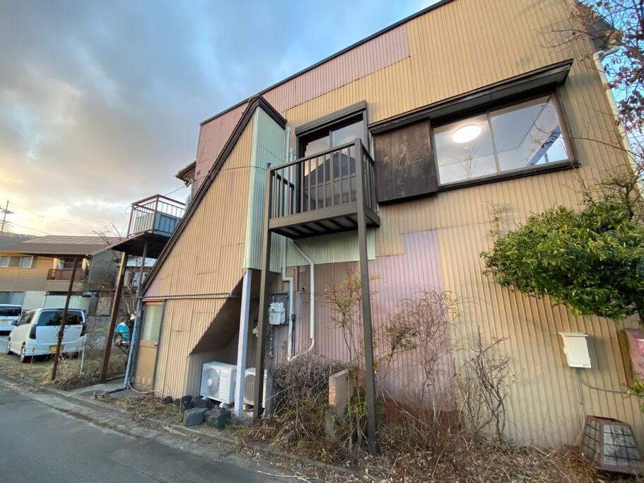 a building with a balcony on the side of it at FTH Moon Light 3min to Sta. in Shimo-yoshida