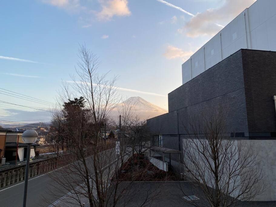 a building with a view of a mountain in the background at FTH Moon Light 3min to Sta. in Shimo-yoshida