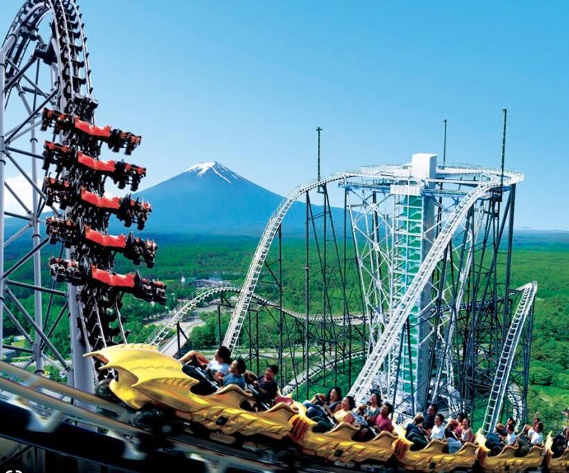 a group of people riding on a roller coaster at FTH Moon Light 3min to Sta. in Shimo-yoshida