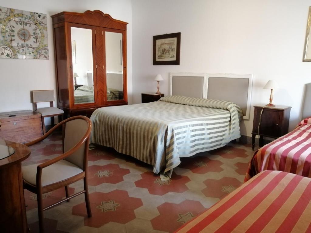 Posteľ alebo postele v izbe v ubytovaní Palazzo Benso
