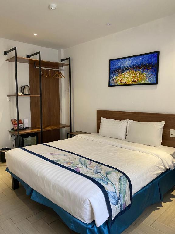 Postel nebo postele na pokoji v ubytování Essenza Hotel Đà Nẵng