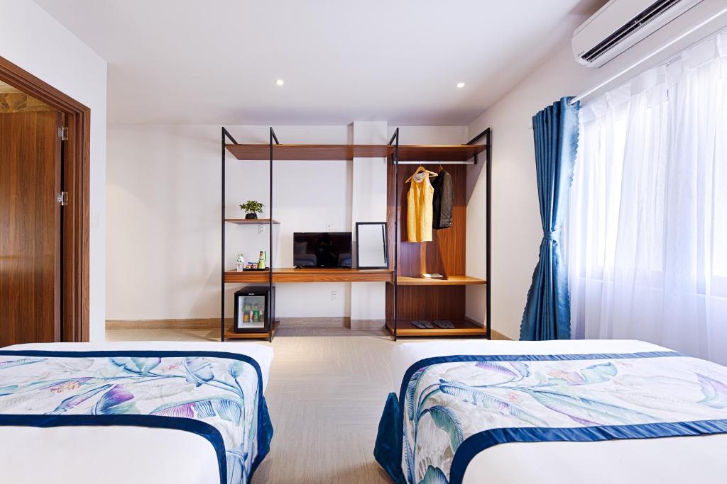 Postel nebo postele na pokoji v ubytování Essenza Hotel Đà Nẵng