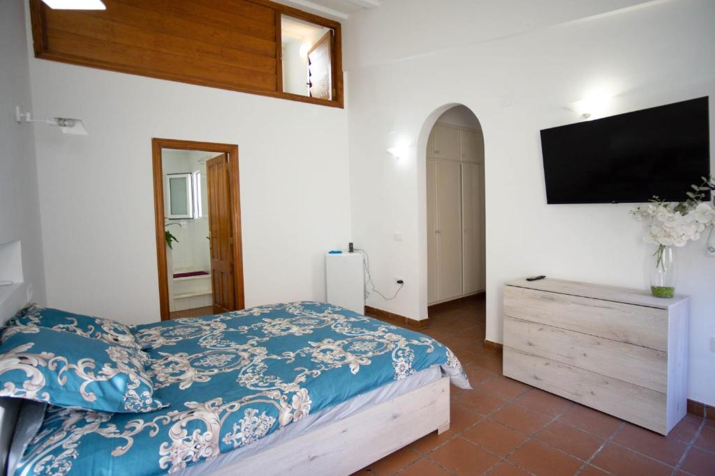 a bedroom with a bed and a flat screen tv at Residencial Art Brut in Castellón de la Plana