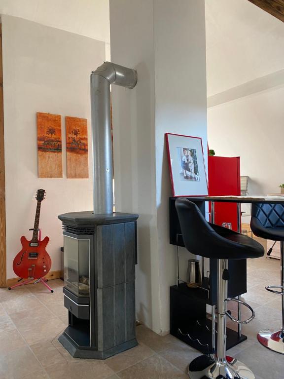 a wood stove in a room with a table and a chair at City Apartment in Schweinfurt