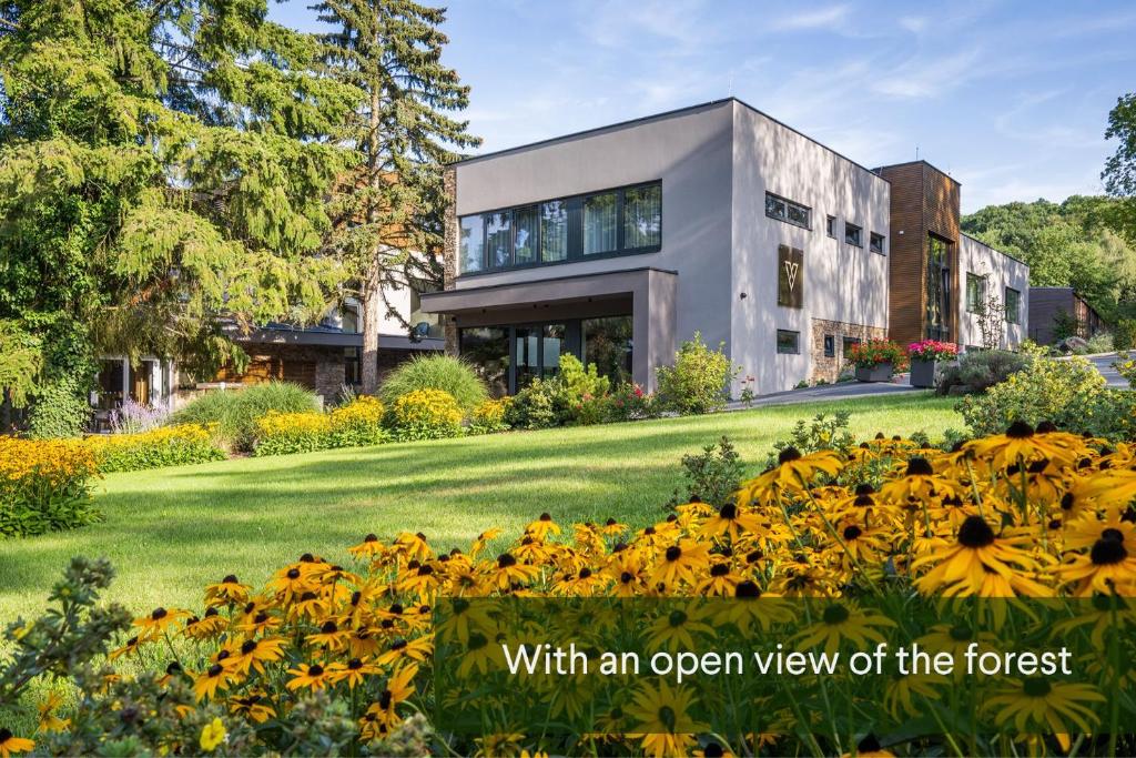 an open view of a house with flowers in the foreground at Vista Resort & Club in Prague