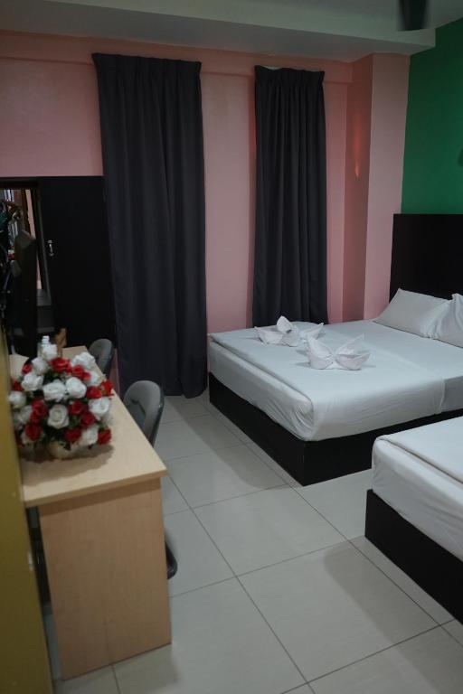 Postel nebo postele na pokoji v ubytování Hotel Victory Inn KLIA and KLIA 2