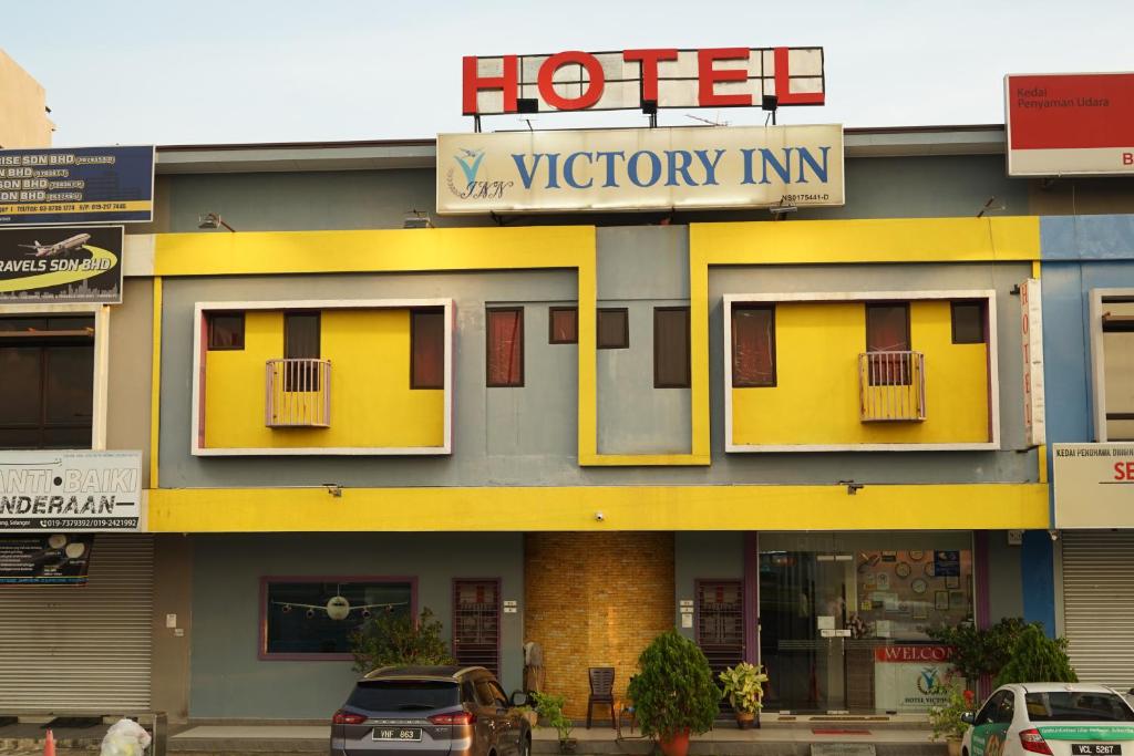 a hotel with a sign on the front of it at Hotel Victory Inn KLIA and KLIA 2 in Sepang