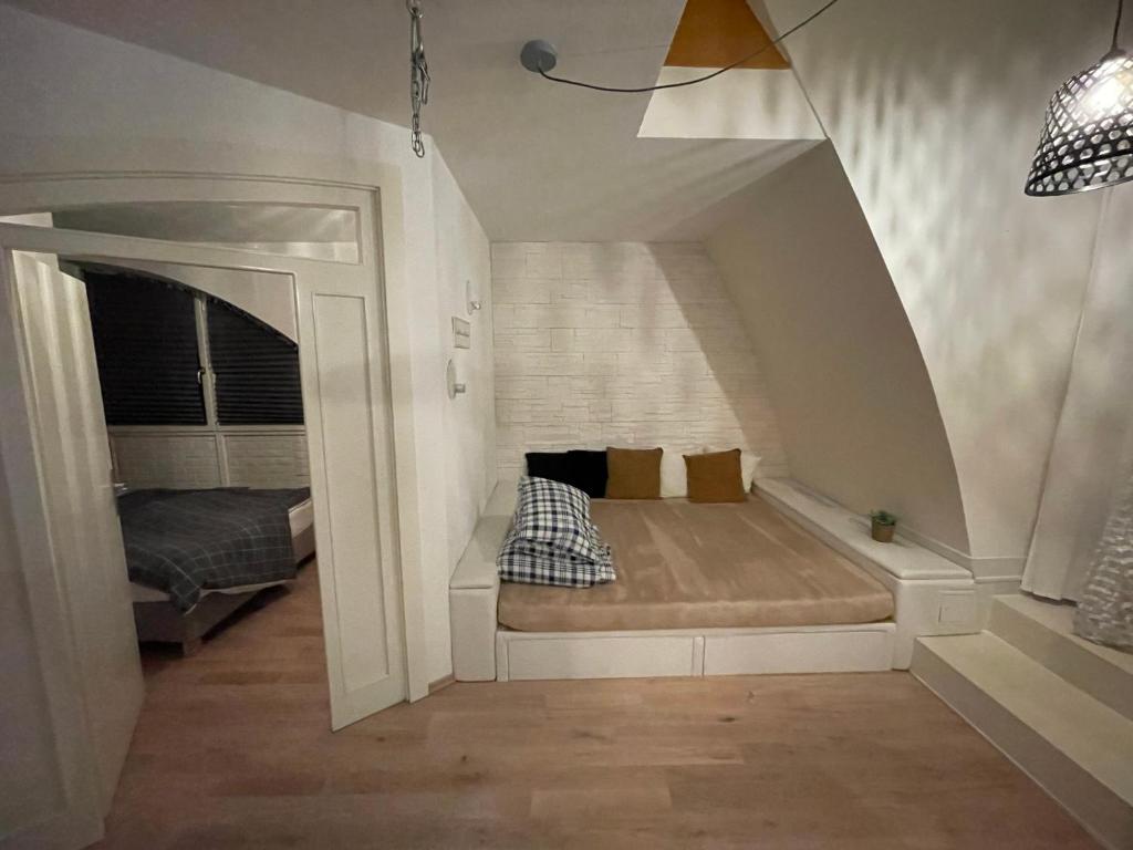 a small room with a bed in the attic at Vienna terraced Apartment in Vienna