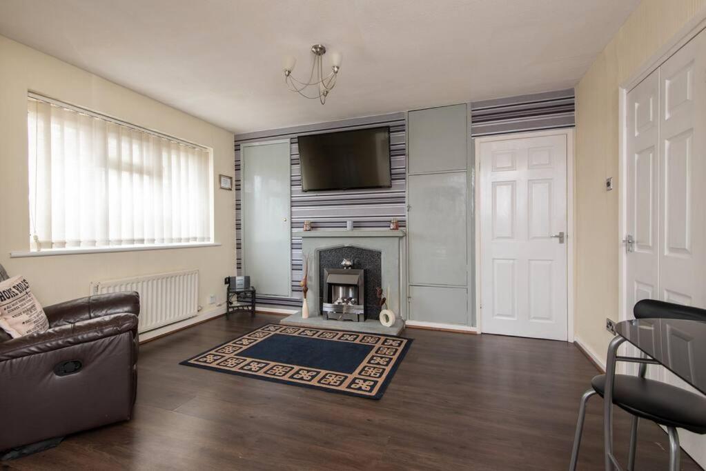 a living room with a fireplace and a couch at Barden Moor in Darlington