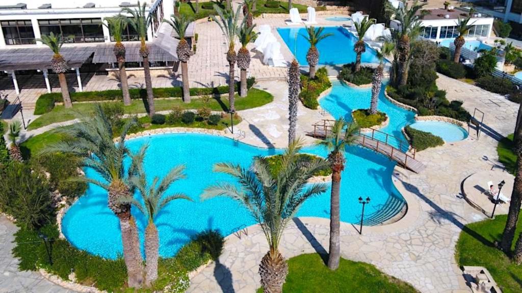 an aerial view of a swimming pool at a resort at Sandy Beach Hotel & Spa - ex Sentido in Larnaca