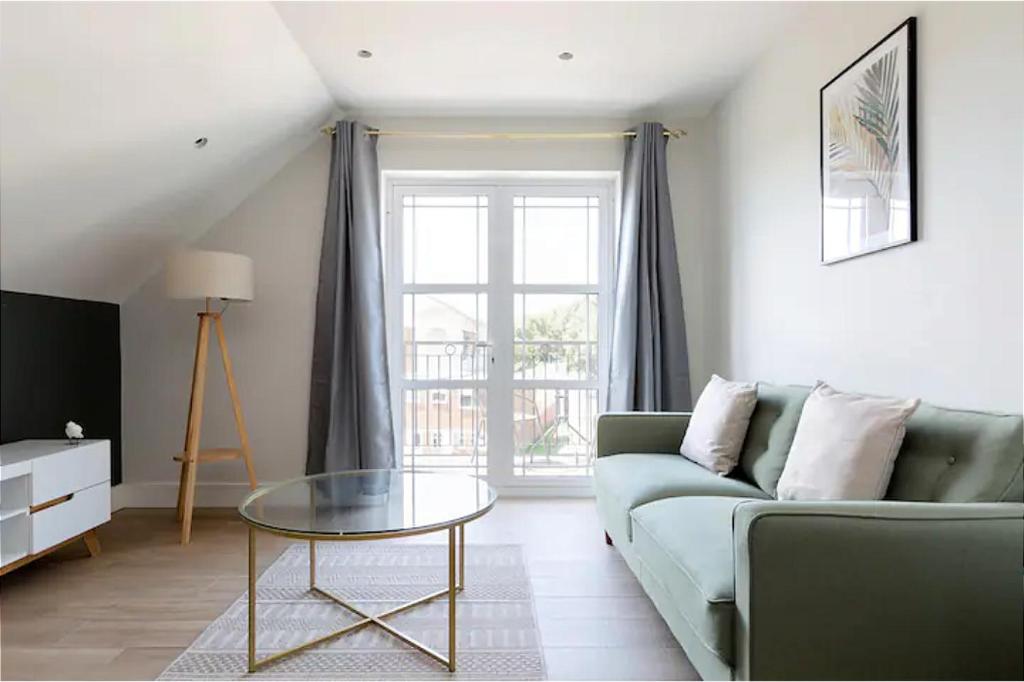 a living room with a couch and a glass table at The Finchley Apartments in Hendon