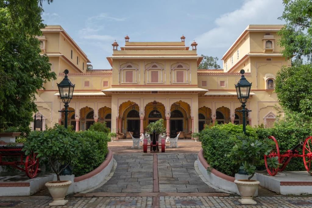 a large building with a courtyard in front of it at Hotel Narain Niwas Palace in Jaipur