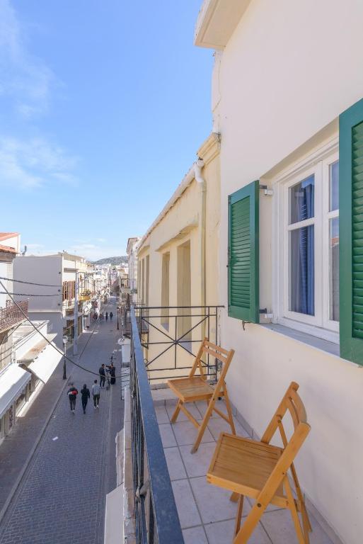 a balcony with benches on the side of a building at Rethymno Heart Apartment in Áyios Andónios