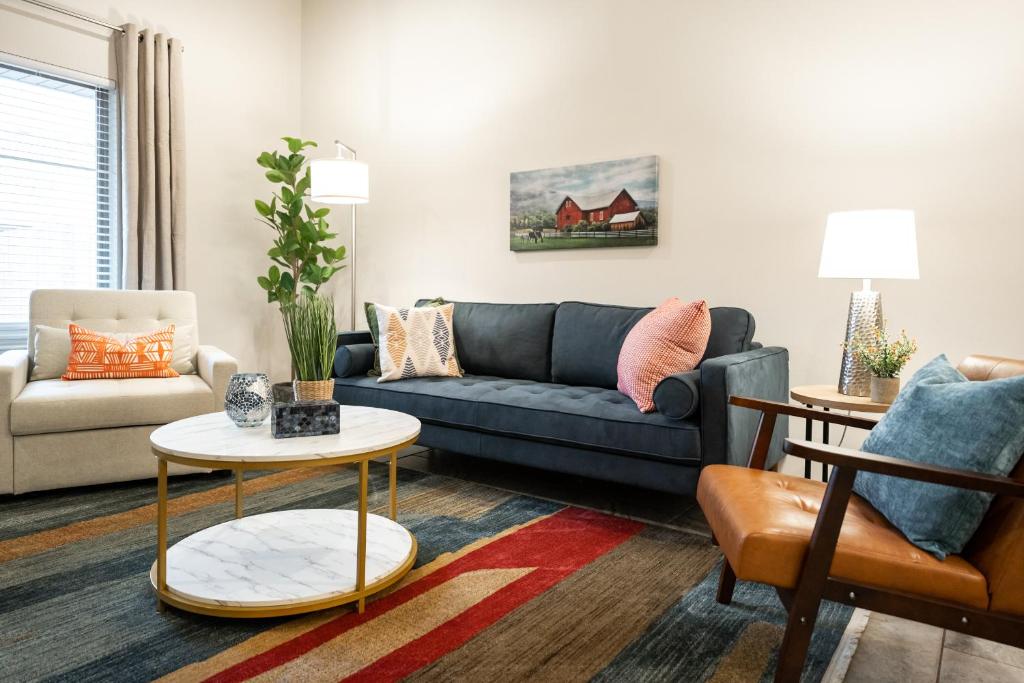 a living room with a couch and a table at Luxury Lubbock Home Retreat near Texas Tech in Lubbock